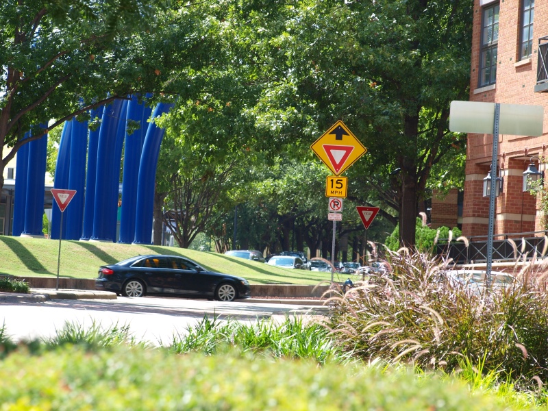 A photo of a car going around Addison Circle in Addison, Texas.